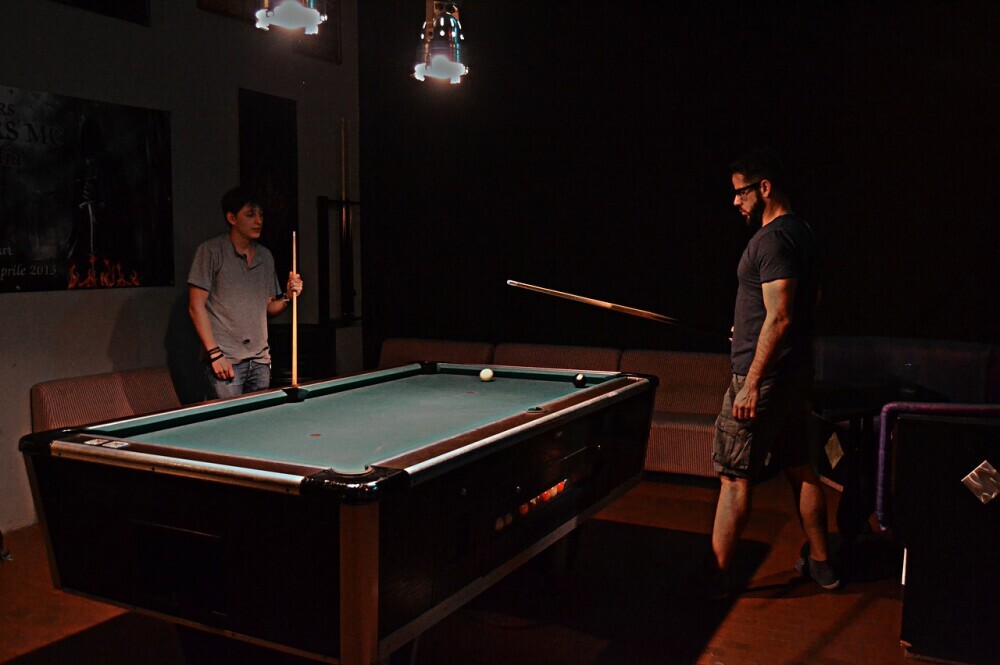 Men playing billiards on a pool table